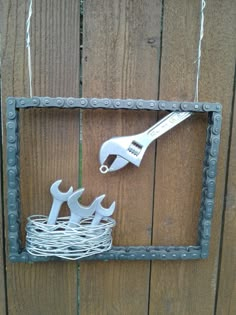 a metal frame with scissors and wire in the shape of a bird's nest