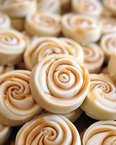 some very pretty looking cookies with swirls on it's sides and the top one is white