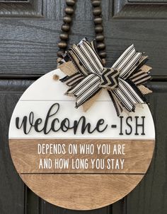 a welcome sign hanging on the front door