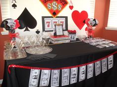 the table is set up with cards, casino chips and glasses for poker party decorations