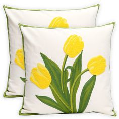 two yellow tulips embroidered on white pillows