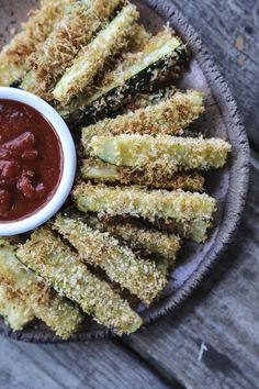 fried zucchini sticks on a plate with dipping sauce