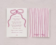 a pink and white wedding card with a bow on it's side, next to a striped envelope