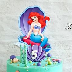 there is a birthday cake with a little mermaid on it