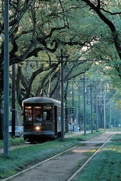 a trolley car is traveling down the tracks