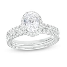 Make a standout statement of affection with this dazzling oval lab-created diamond frame bridal set. Fashioned in 14K white gold The engagement ring showcases a 1 ct. certified oval-shaped lab-created diamond boasting a color rank of I and clarity of Si2. Lab-created diamonds line the halo frame and the shank. Seal your vows with the coordinating lab-created diamond-lined wedding band. Includes certification card This bridal set captivates with 1-3/4 cts. t.w. of lab-created diamonds. Diamond Frame, Peoples Jewellers, Oval Cut Diamond, Oval Stone, Bridal Set, Bridal Sets, Diamond Stone, Lab Created Diamonds, Stone Settings