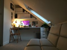 a living room filled with furniture and a flat screen tv on top of a wall