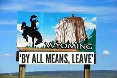 a sign that says wyoming by all means leave