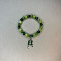 Super cute green beaded bracelet with a frog charm Cheap Green Novelty Bracelets, Green Hand-strung Bracelets For Friendship, Green Bracelets For Friendship, Casual Green Beaded Bracelets With 8mm Beads, Green Hand-strung Jewelry For Friendship, Casual Green Jade Jewelry, Casual Green Hand-strung Beaded Bracelets, Casual Green Beaded Bracelets, Casual Green Bracelet Jewelry