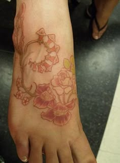 a woman's foot with flowers on it