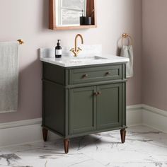 a bathroom sink with a mirror above it and a towel rack on the wall next to it