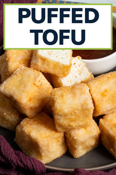 fried tofu cubes on a plate with dipping sauce