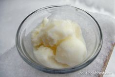 a bowl filled with ice cream sitting on top of a white cloth covered tablecloth