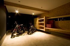 two motorcycles are parked in an empty room