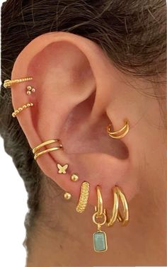 a woman's ear with three different types of piercings