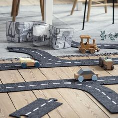 a wooden toy train set on the floor