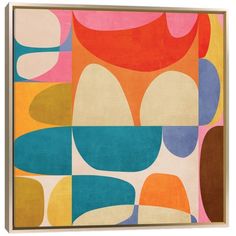 an abstract painting with different colors and shapes on the wall above it is a wooden frame