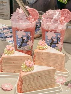 there are three slices of cake with pink frosting on the top and one slice is cut in half