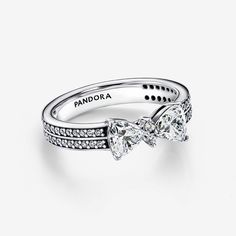 The Sparkling Bow Double-row Ring, crafted from sterling silver, adds a festive touch to any outfit. This ring features a contemporary bow motif surrounded by clear cubic zirconia, as well as a double row of pavé stones on the band’s exterior. Ideal for special occasions or to brighten up your everyday look, this design symbolizes joy and celebration. Style it with your go-to pieces to elevate your outfit. - Pandora Sparkling Bow Double-row Ring - Sterling silver / Cubic Zirconia / Clear - Sz. 4 Body Jewelry Diy, Charms Disney, Pandora Essence, Bracelet Tennis, Jewelry Accessories Ideas, Cute Wedding Ideas, Jewelry Lookbook, Bow Set, The Band