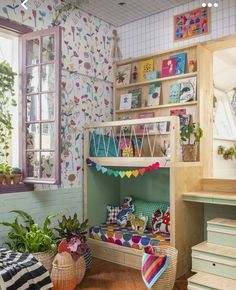 a child's bedroom with a bunk bed and colorful wallpaper on the walls