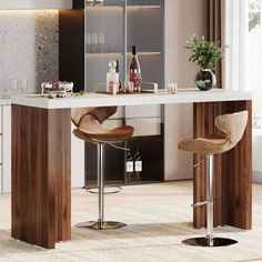 a modern kitchen with bar stools and an island table in front of the counter