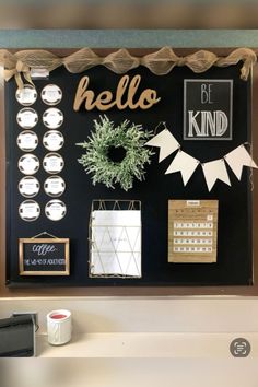 a black board with white and gold decorations on it that says hello, be kind