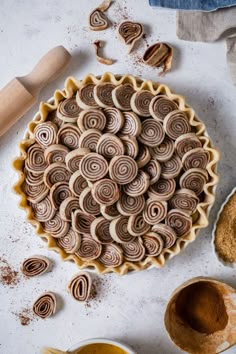 an uncooked pie sitting on top of a table next to other baking supplies