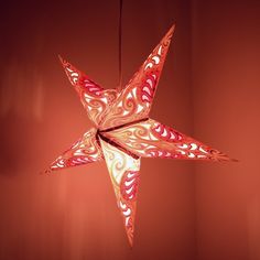 an origami star hanging from the ceiling