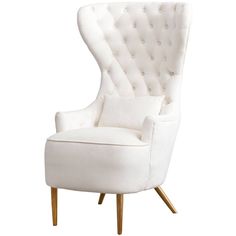 an upholstered white chair with wooden legs and buttons on the armrests