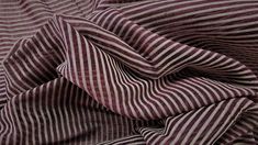 a close up view of a purple and white striped fabric