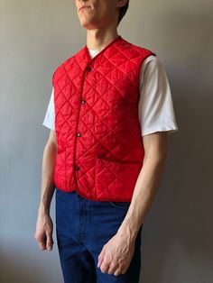 Quilted Waistcoat / Quilted Vest / Size M / 1990s  This vintage quilted vest wonderful condition! - made in Italy - ERA - circa 1990's - color - red - 2 outside pockets - 4 stud buttons at front - material - 100% polyester - label size - M (watch measurements) FLAT Measurements: Shoulders: 39cm Chest (underarm to underarm): 50cm Length(back): 62cm Pay your attention to that  most antique items have been used and may have minor flaws. Please , read the description carefully and check the measurem Vintage Spring Vest Outerwear, Quilted Vest For Winter Streetwear, Casual Quilted Cotton Vest, Classic Red Winter Vest, Classic Red Sleeveless Outerwear, Vintage Vest Outerwear For Streetwear, Vintage Style Vest Outerwear For Streetwear, Vintage Quilted Outerwear For Spring, Vintage Winter Vest Outerwear