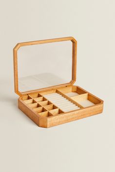 an open wooden box containing several compartments