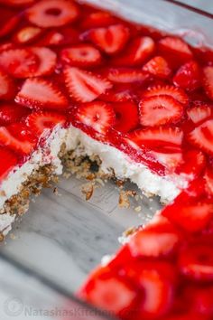 a close up of a cake with strawberries on it's top and bottom