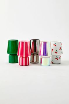 several different colored cups sitting next to each other