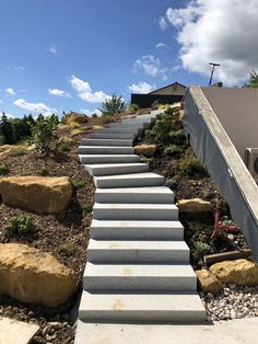 there are many steps going up to the top of this hill with rocks on each side