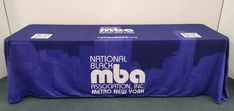 a purple table with the national black maa association logo on it is in front of a white wall