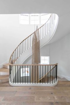 a spiral staircase in a house with white walls