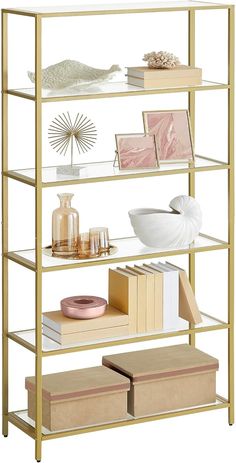 a gold shelf with books, magazines and other items on it's shelves against a white background