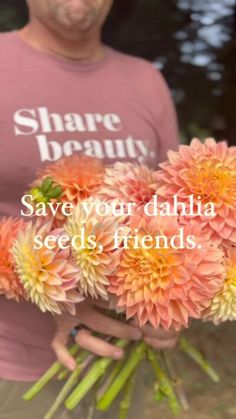 a man holding flowers with the words save your dahlia seeds friends