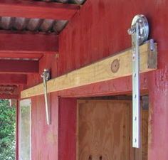 the inside of a building with red walls and wood trimmings on the ceiling