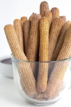 a glass bowl filled with sugar coated corn on the cob