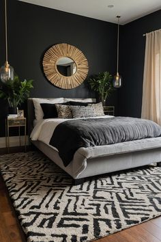 a bedroom with black walls, white and gray bedding, gold accents and a round mirror on the wall