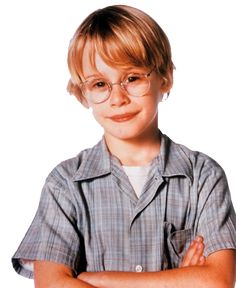 a young boy wearing glasses with his arms crossed