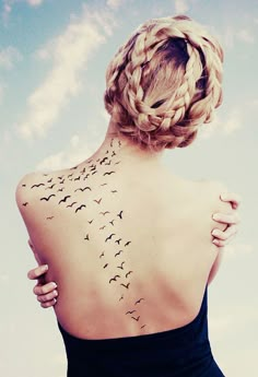 a woman with birds on her back