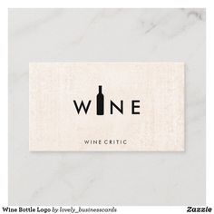 a wine bottle logo on a white marble surface with the word wine written in black