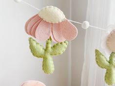 three felt flower mobiles hanging from a string