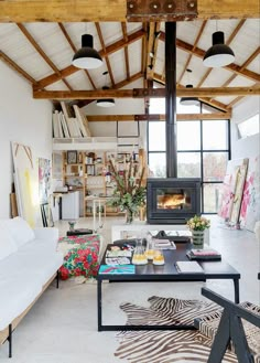 a living room filled with furniture and a fire place