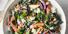 a white bowl filled with lots of different types of food on top of a table