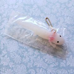 a plastic keychain with a pink and white mouse in it's pouch