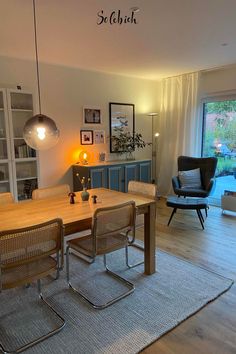 a dining room table and chairs in front of a sliding glass door